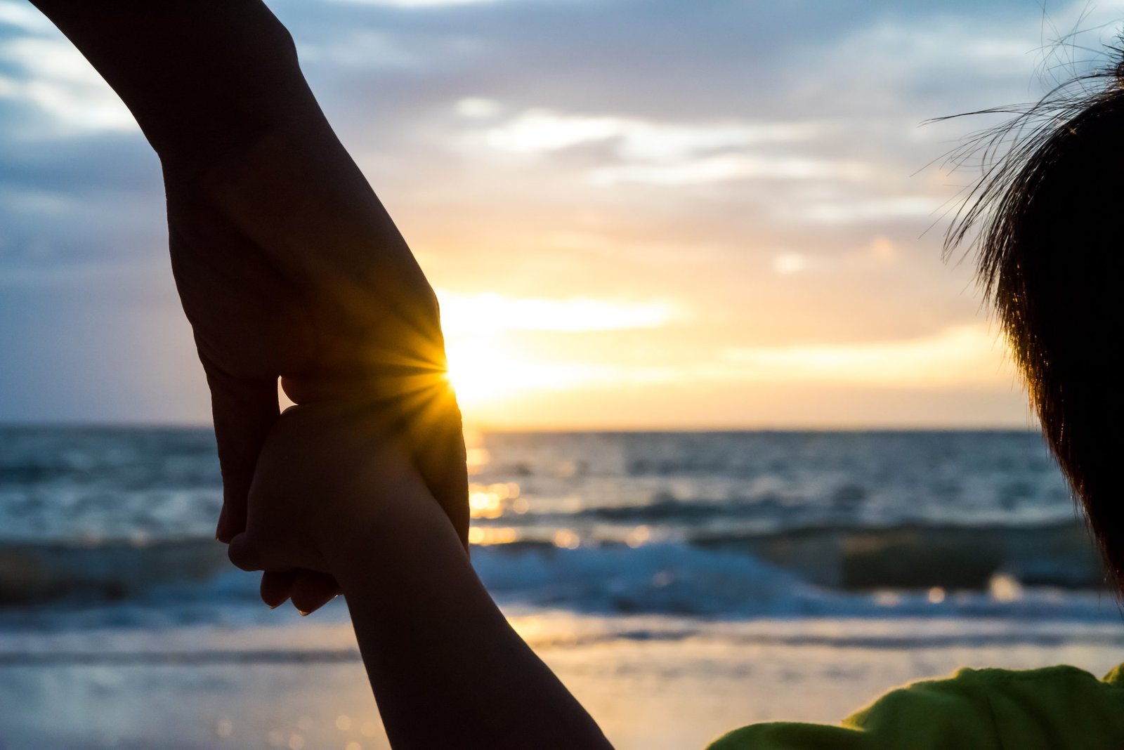 soft focus parent hold the little child hand during sunset, warm soft focus parent hold the little child hand during sunset, warm tone.