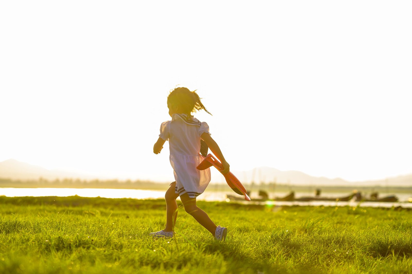 happy family .Girl runs kite in summer green pasture